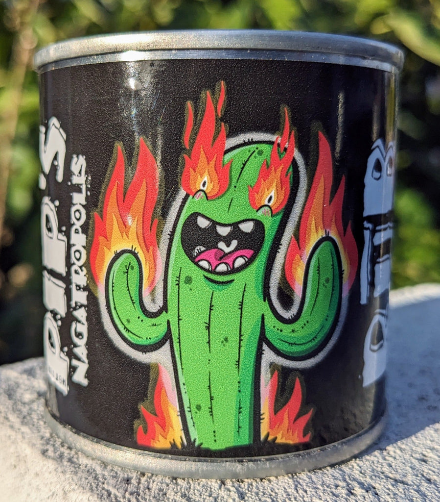 A can of Pip's Nagatropolis dry rub featuring a cartoon illustration of a green cactus with a fierce expression, its arms raised, and flames coming from its head and sides, set against a black background.